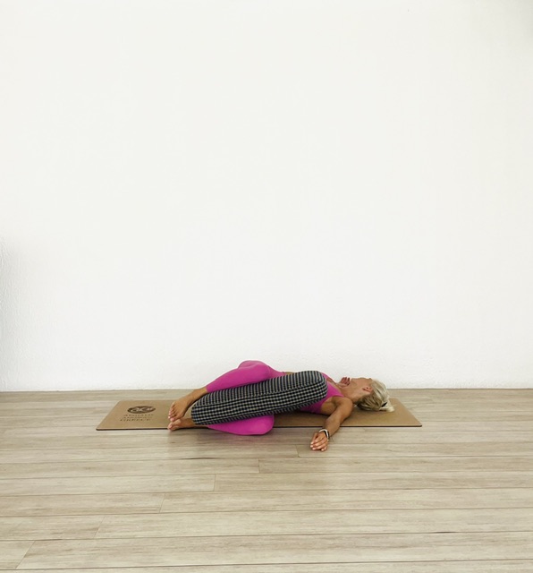 Restorative evening yoga spinal twist